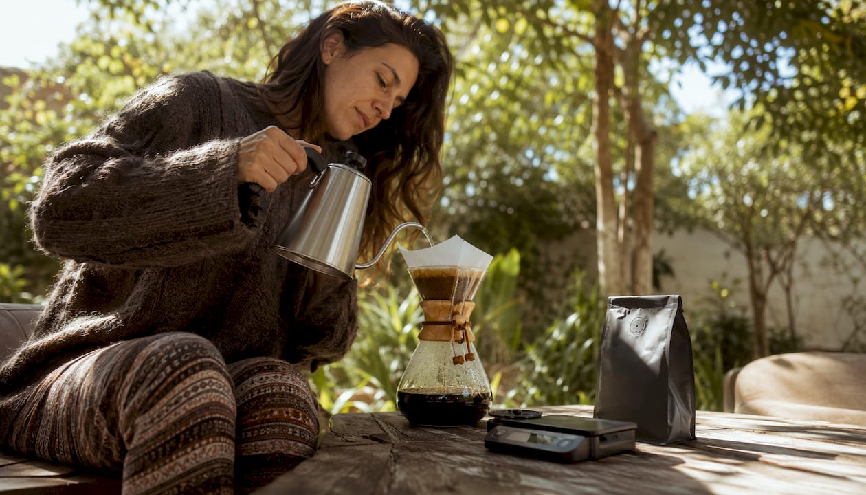 Woman brewing coffee with Chemex at home