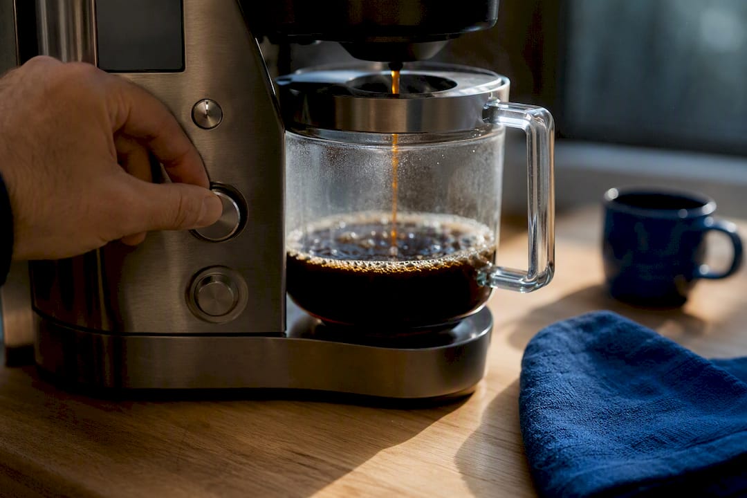 Barista adjusting coffee brewer settings